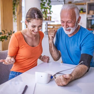 Man Taking Blood Pressure With Granddaughter